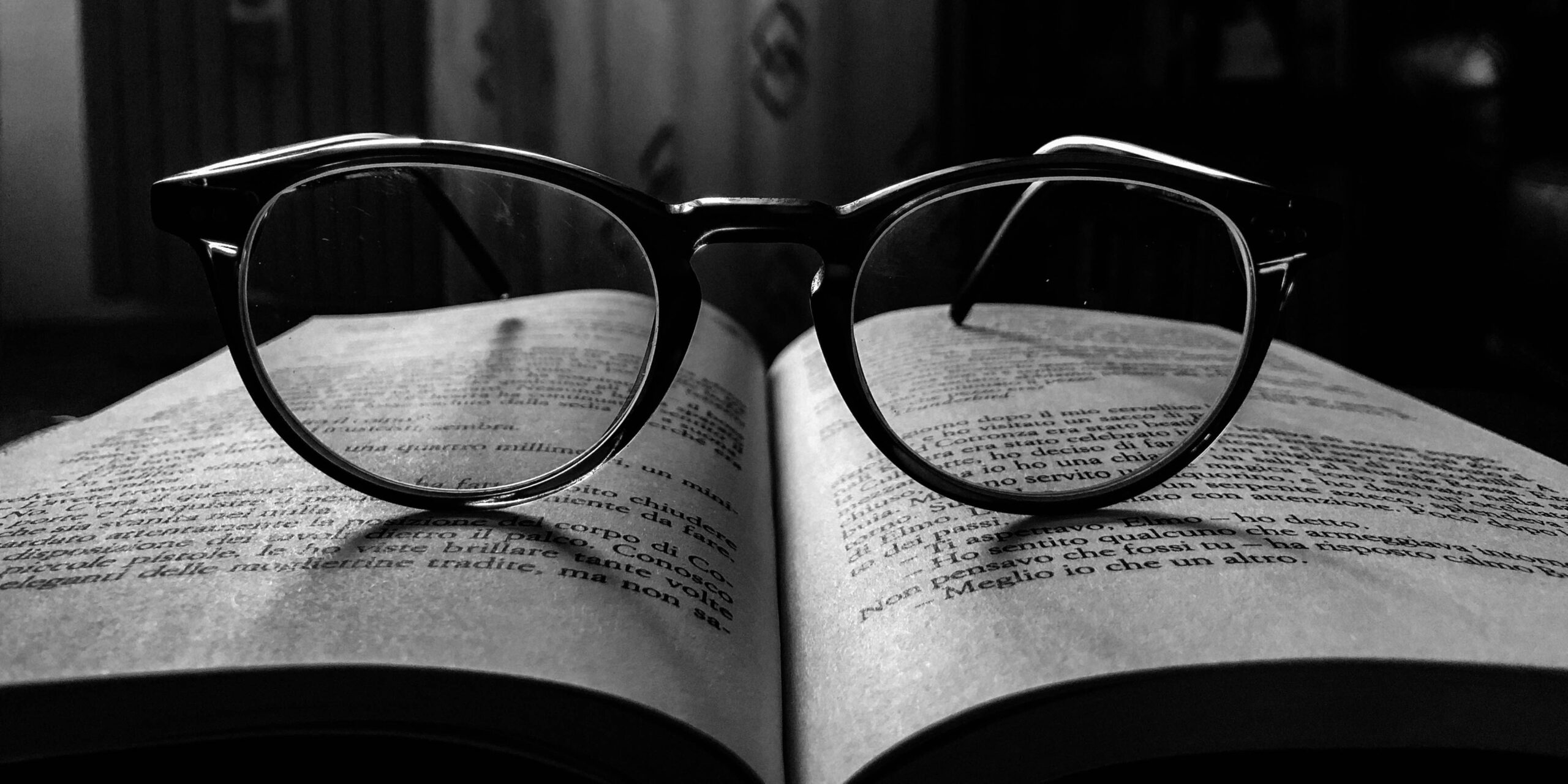 black frame eyeglasses on book