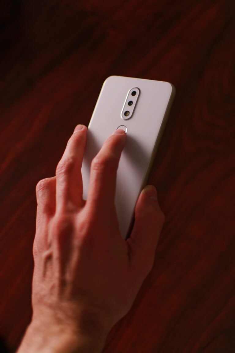 man holding white smartphone