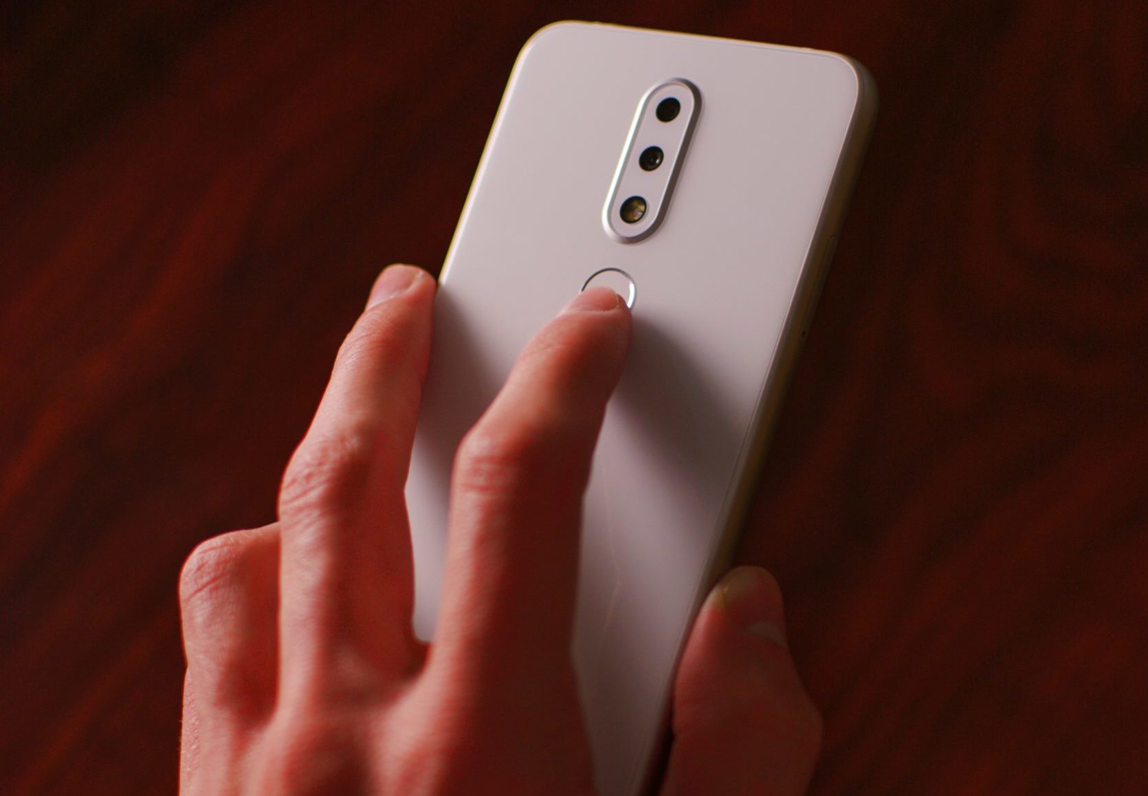 man holding white smartphone